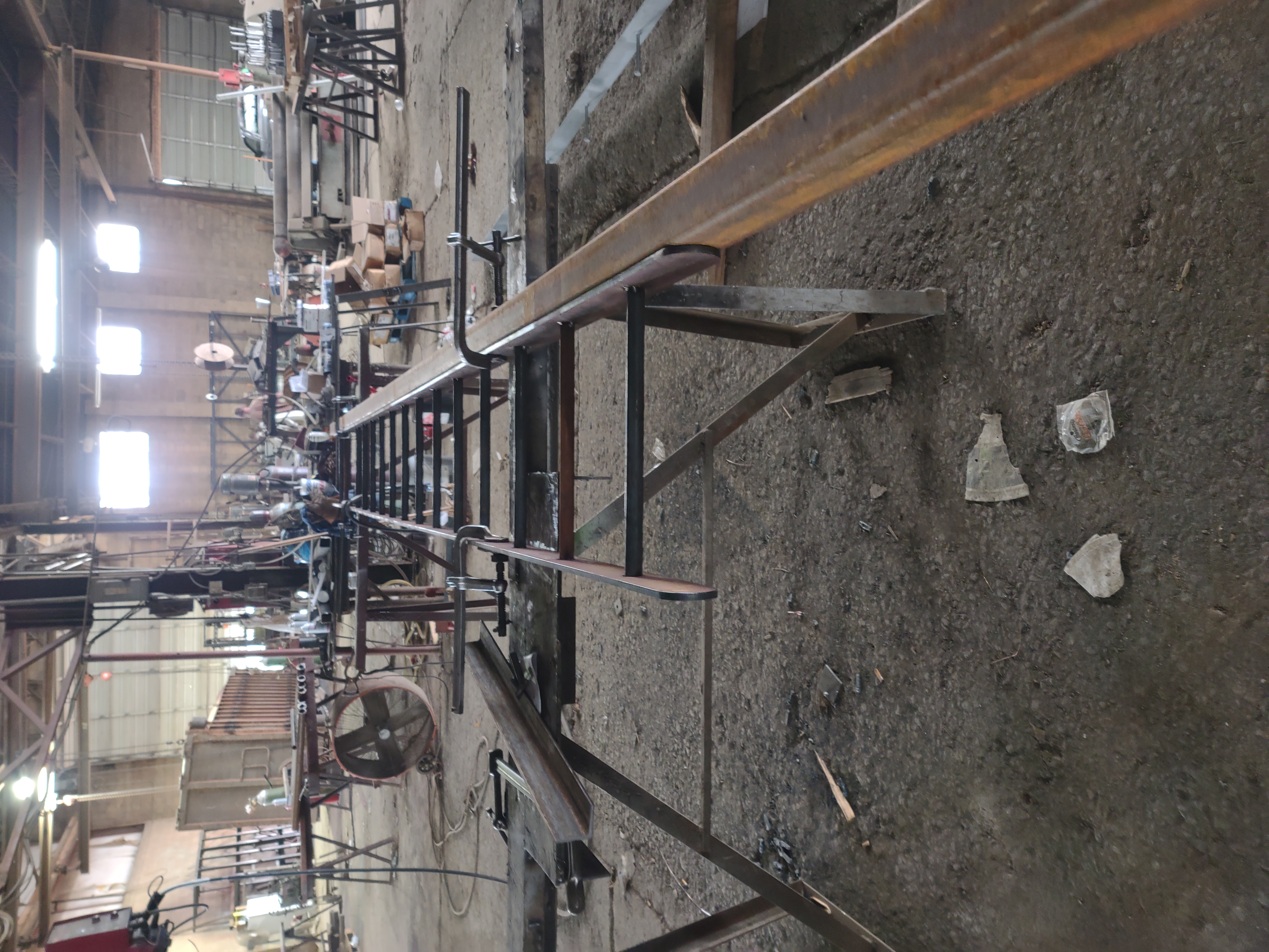 Welder's custom-fabricated 12 foot steel ladder showing clean weld joints