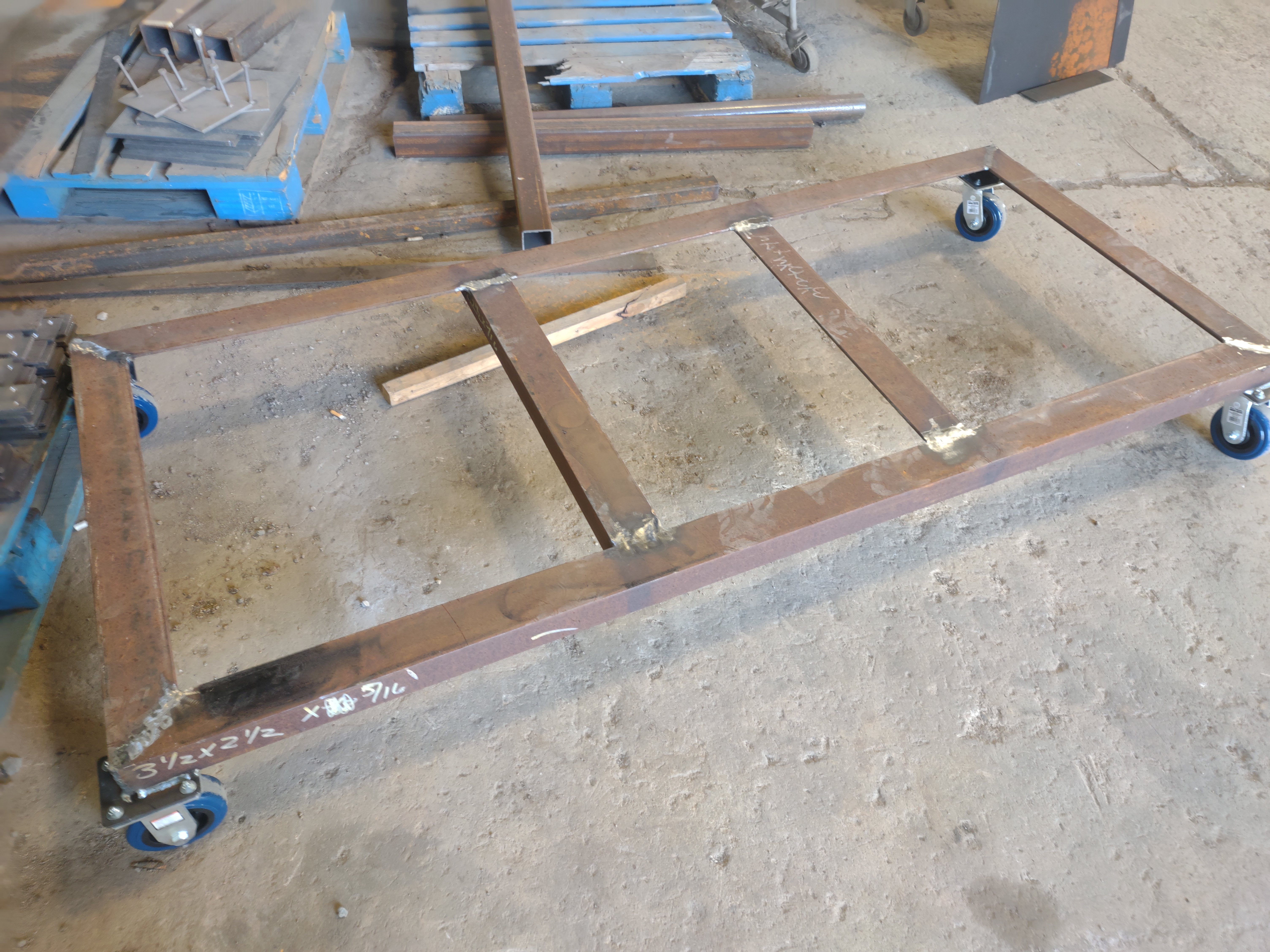 Fabricated rolling skid base with welded frame and casters
